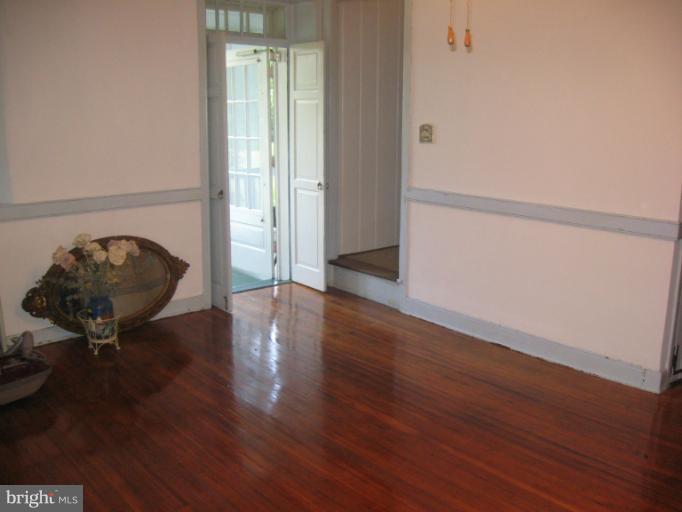 24 Houck Road Westminster, MD 21157 - Photo 4 of 14 a view of a room with wooden floor and a window