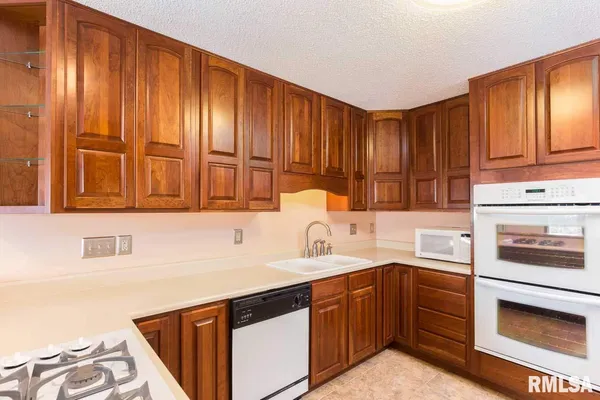 a kitchen with wooden cabinets and sink