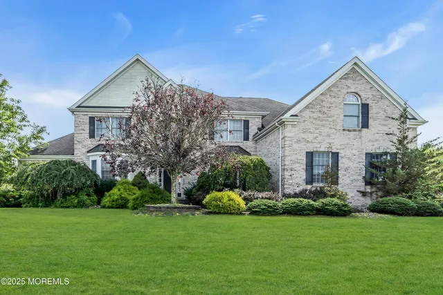 a front view of house with a garden