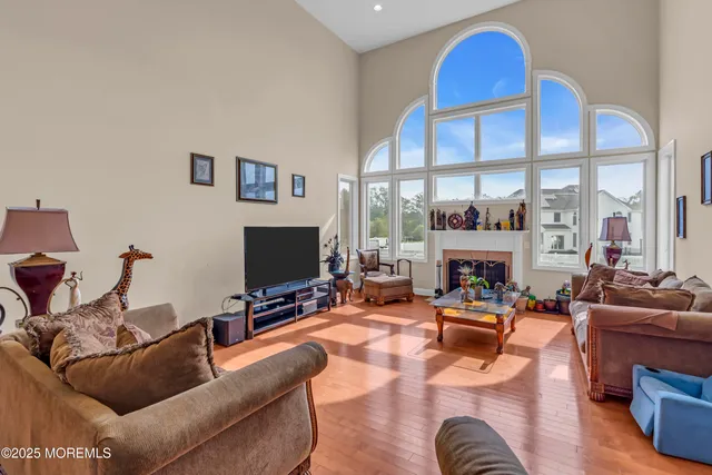 a dining room with furniture and a large window