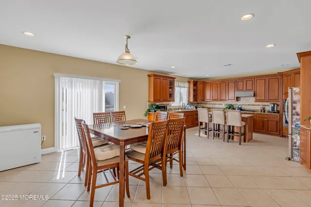 a kitchen with stainless steel appliances granite countertop wooden cabinets a sink and dishwasher a refrigerator with wooden cabinets