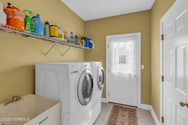 a spacious bedroom with a bed a couch and dresser