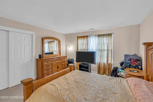 a view of walk in closet with clothes