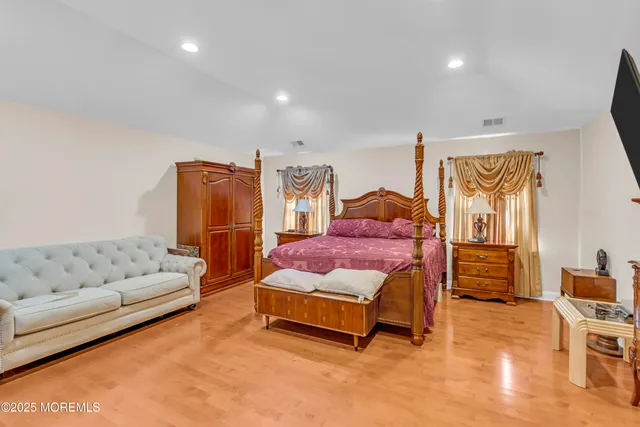 a bedroom with a bed and a dresser