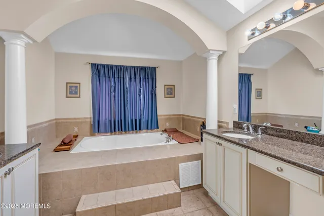 a bedroom with furniture and a flat screen tv