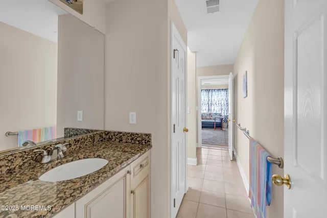 a view of a house with a big yard and large trees