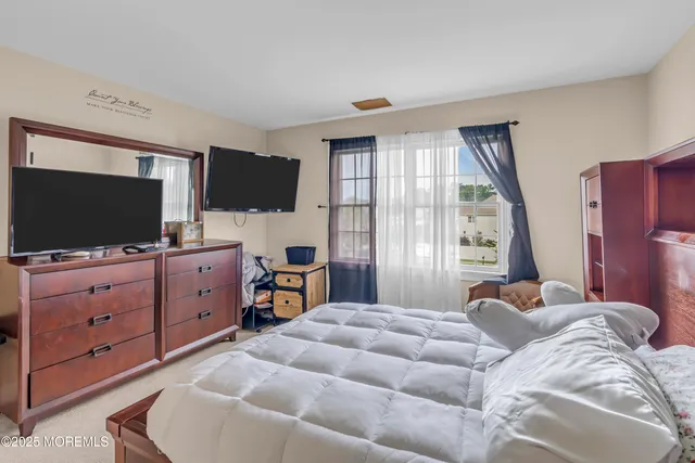 a view of a house with a big yard and large trees