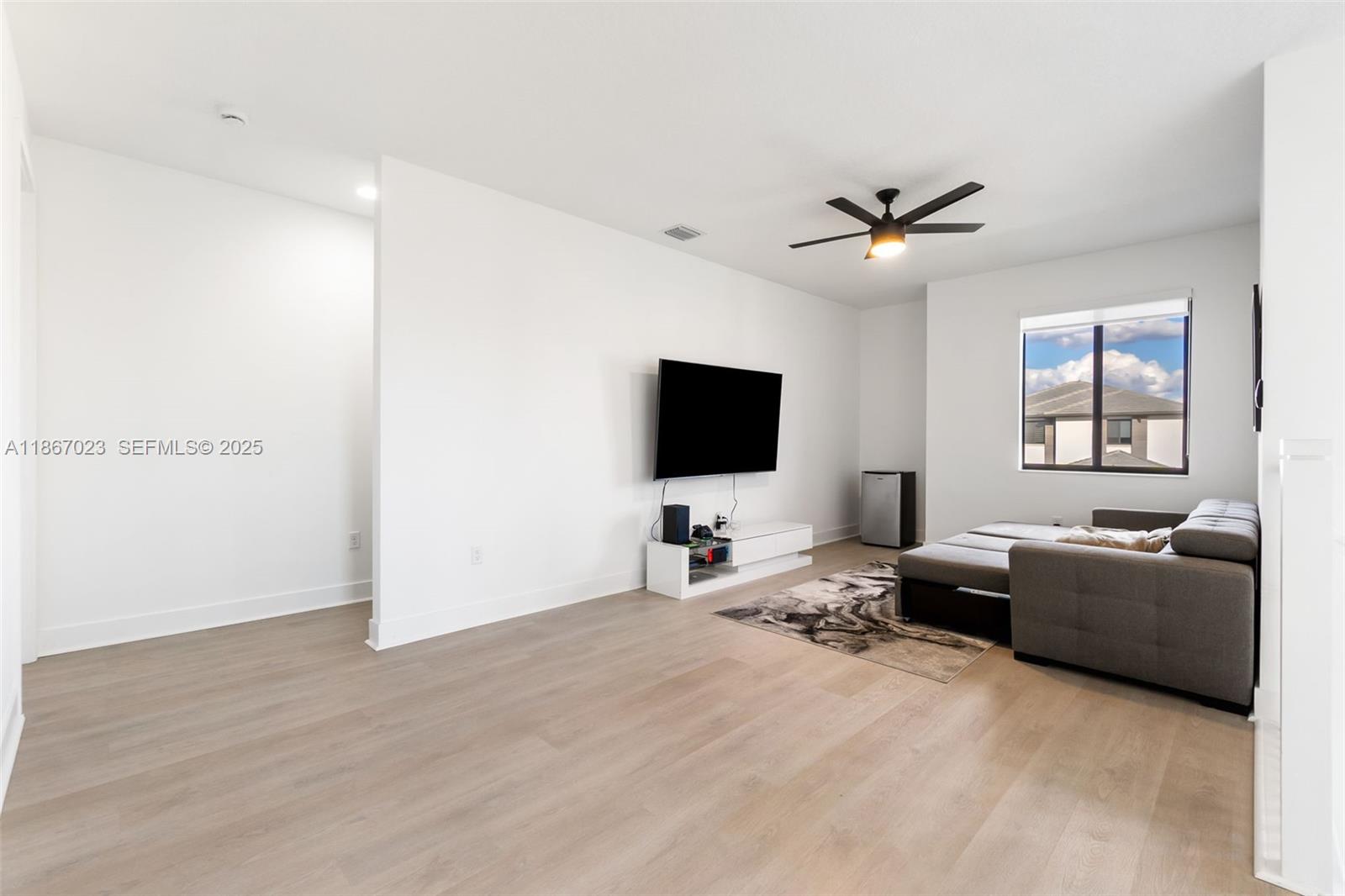 4948 Gambero Way Ave Maria, FL 34142 - Photo 14 of 28 a living room with furniture and a flat screen tv