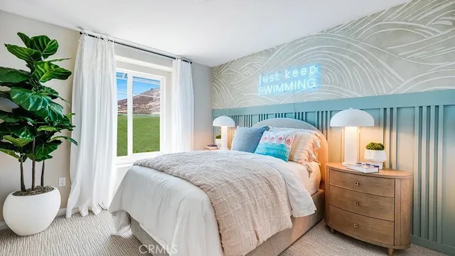 a bedroom with a large bed and a potted plant