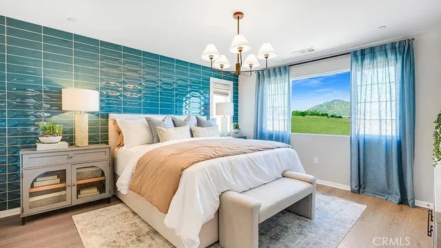 a bedroom with a bed and a chandelier