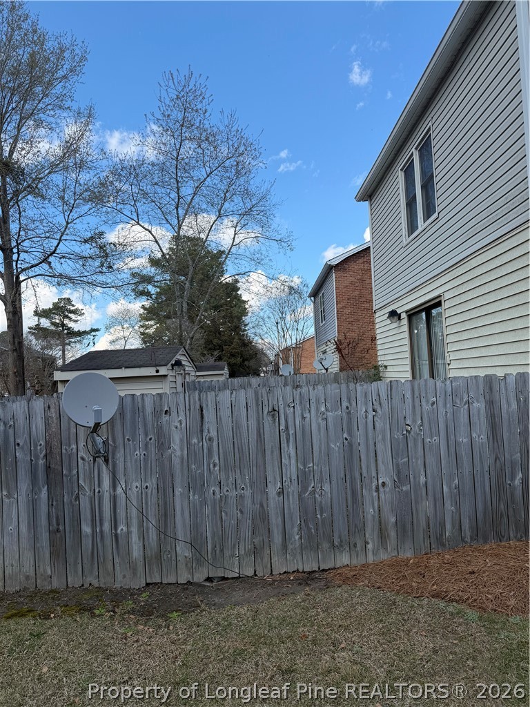 3542 Fayetteville Road Lumberton, NC 28358 - Photo 5 of 5 a view of a backyard with wooden fence