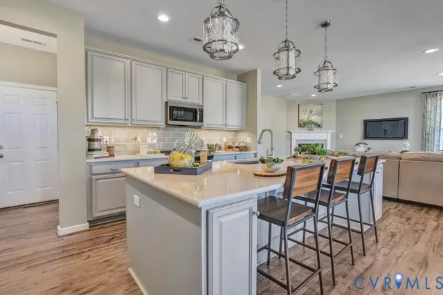 a kitchen with a dining table chairs and cabinets