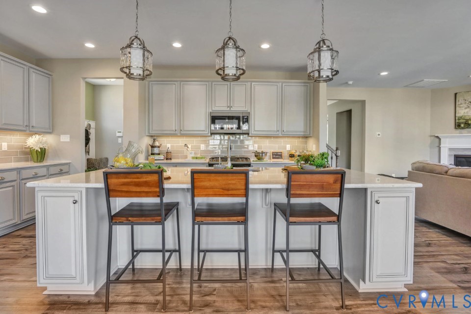 985 Charlemagne Road Midlothian, VA 23114 - Photo 17 of 42 a kitchen with kitchen island granite countertop a view of living room and stainless steel appliances
