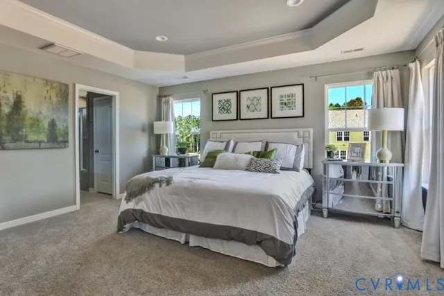 a bedroom with a bed a stove a mirror and furniture