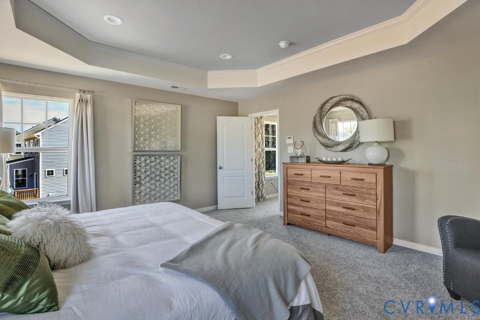 985 Charlemagne Road Midlothian, VA 23114 - Photo 22 of 42 a bedroom with a bed a stove a mirror and furniture