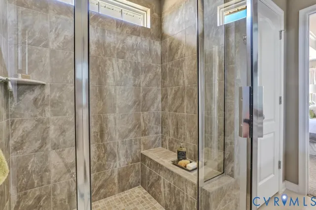 a en suite bathroom with a granite countertop sink and a mirror