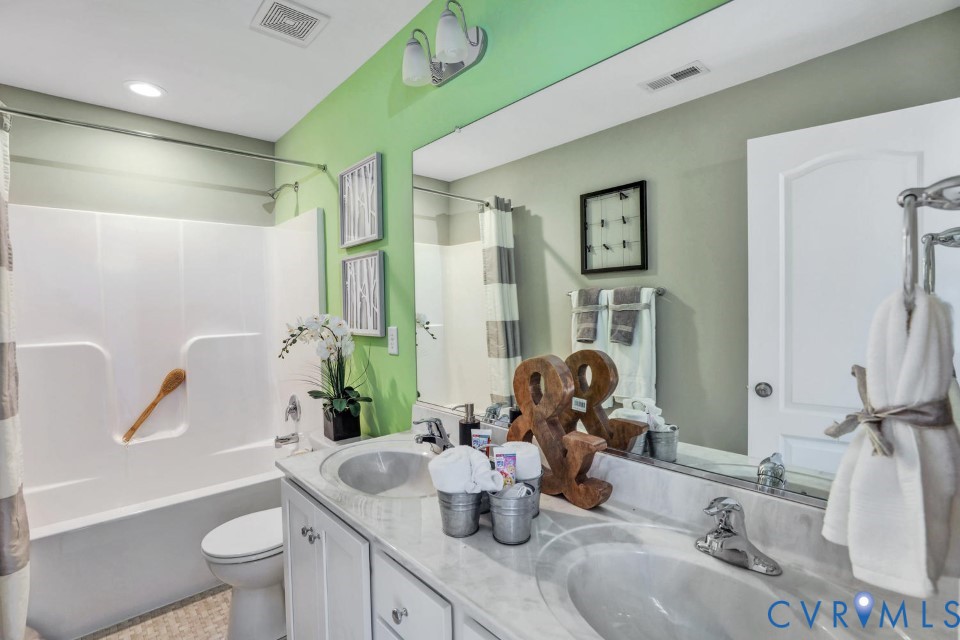 985 Charlemagne Road Midlothian, VA 23114 - Photo 28 of 42 a bathroom with a granite countertop sink a toilet a mirror and shower