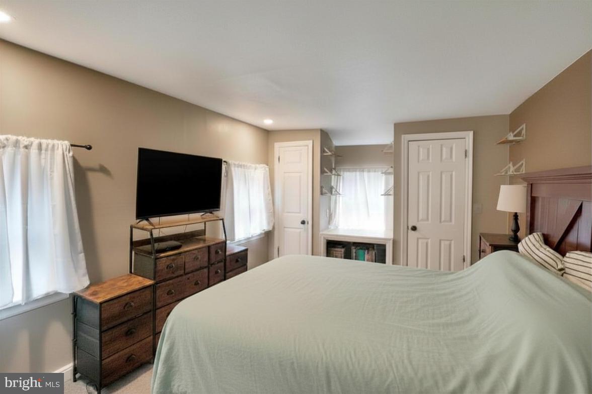 53 Main Street Oley, PA 19547 - Photo 19 of 26 a bedroom with a bed and a flat tv screen on wall