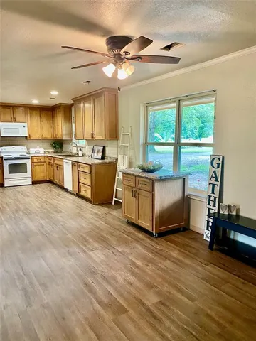 a living room with kitchen island furniture and a kitchen view