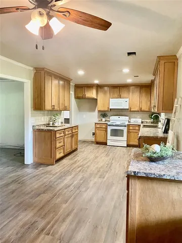 a kitchen with stainless steel appliances granite countertop a stove oven and a refrigerator