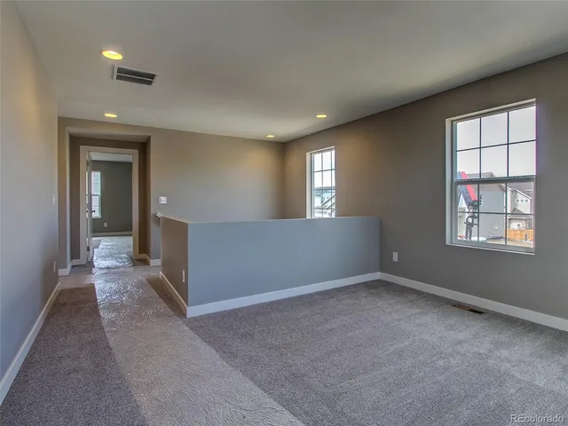 an empty room with windows and closet