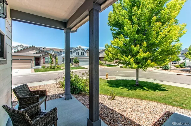 a view of a porch with furniture and garden