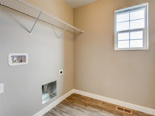 a view of a room with wooden floor and closet