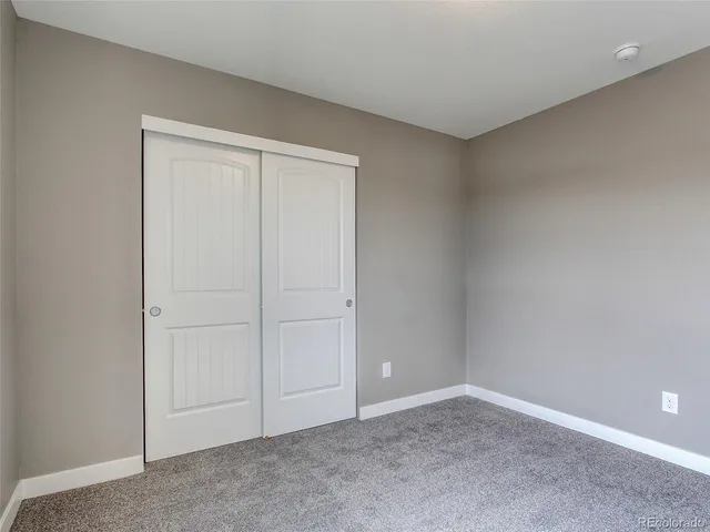 an empty room with closet area