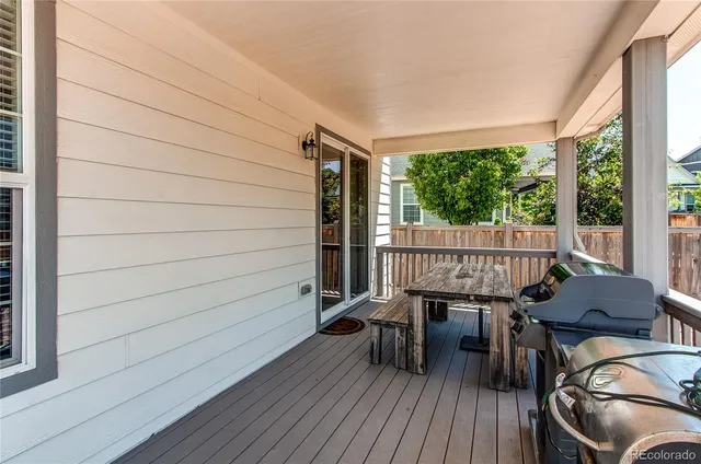 a balcony with table and chairs