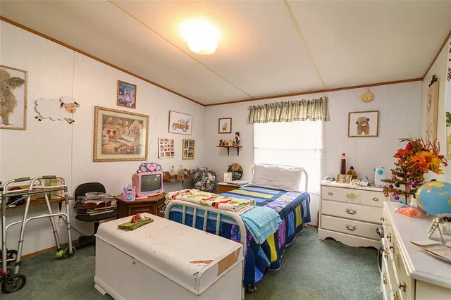 a bedroom that has a bed and a table in it