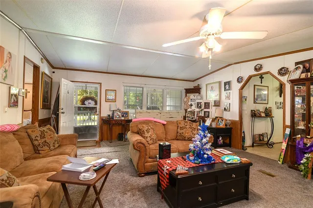 a living room with furniture fireplace and a chandelier