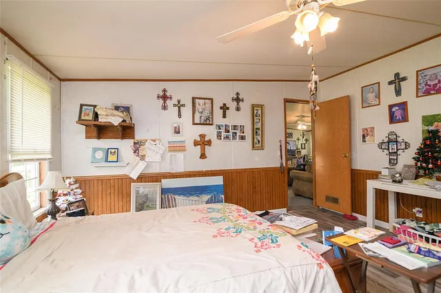 a bedroom that has a bed and a chandelier