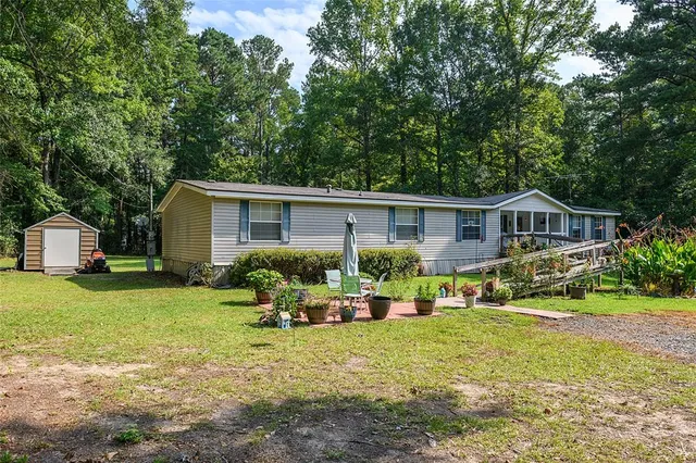 a front view of house with a garden and porch