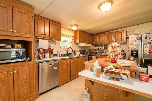 a kitchen with stainless steel appliances granite countertop a sink stove and cabinets