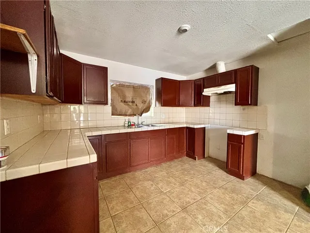 a kitchen with stainless steel appliances wooden cabinets a sink and a stove