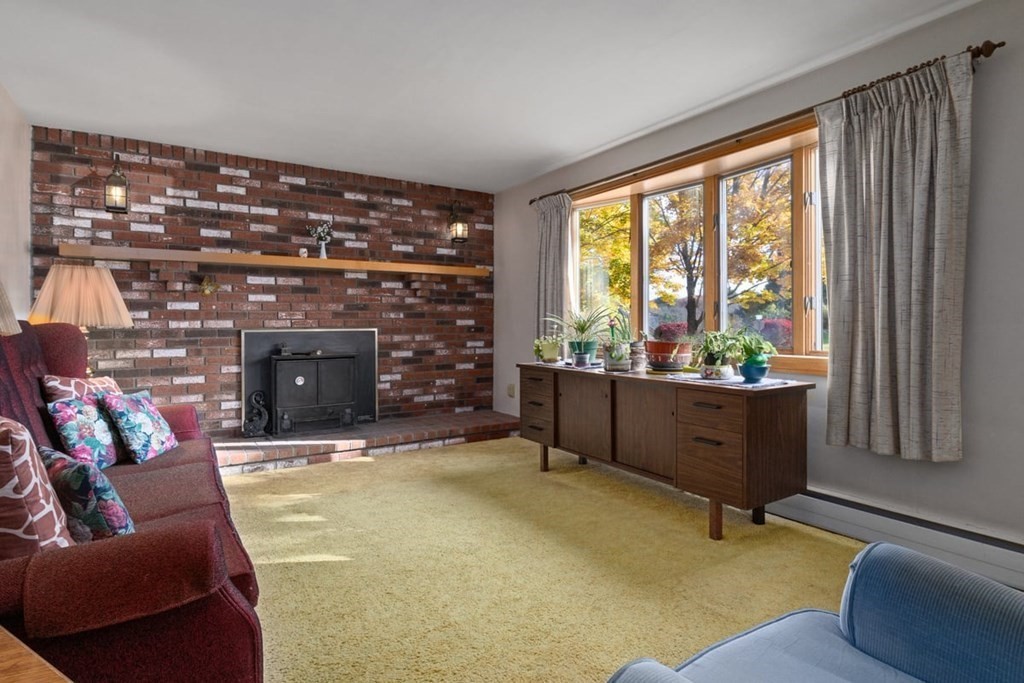 29 Irving Drive Walpole, MA 02081 - Photo 9 of 33 a living room with furniture a fireplace and a window