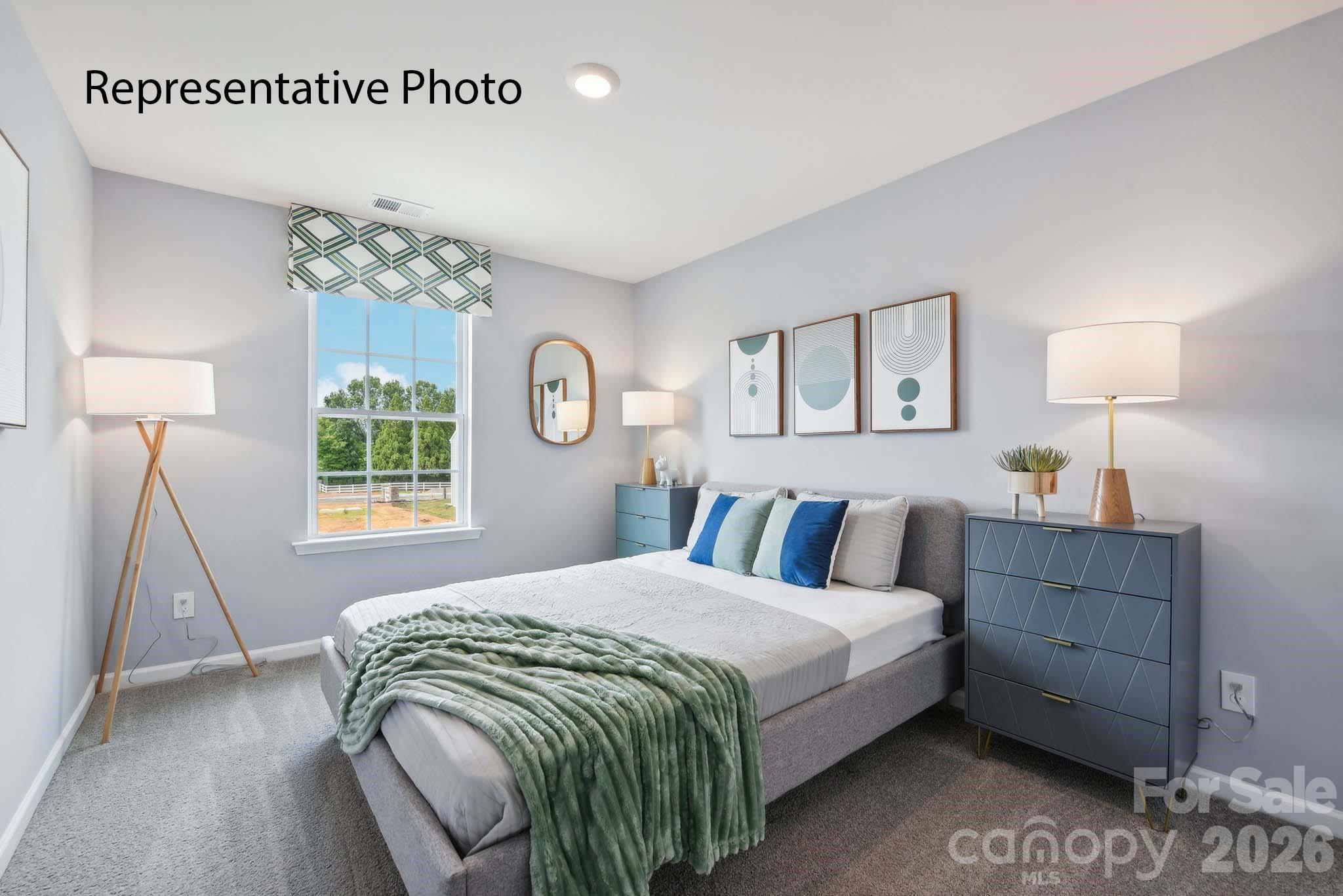 2053 Moorside Court Lancaster, SC 29720 - Photo 12 of 26 a bedroom with a bed a lamp and a window