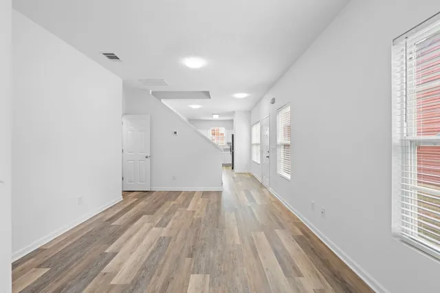 a view of hallway with wooden floor