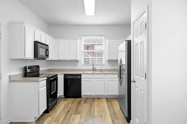 a kitchen with a sink stove and refrigerator