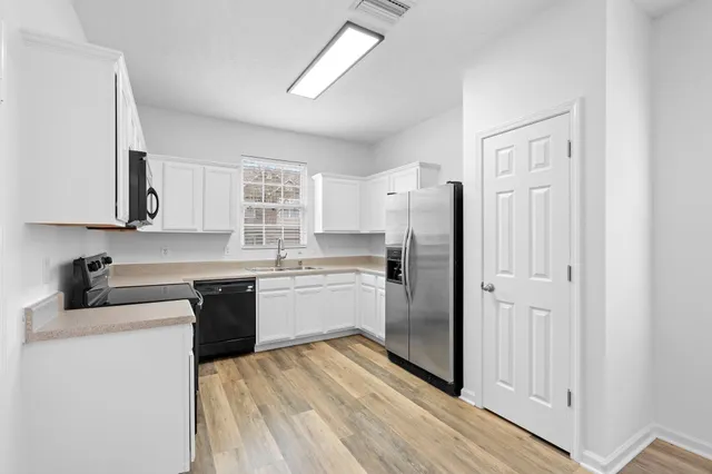 a kitchen with a refrigerator and a sink