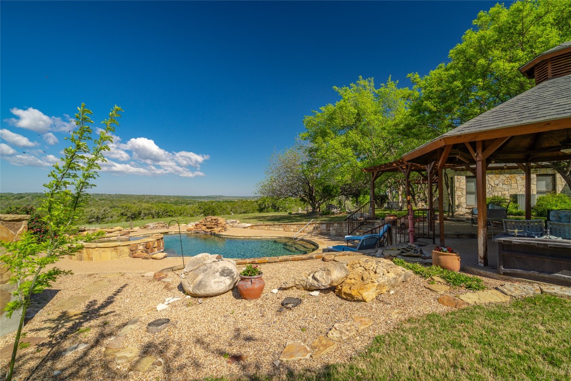 a view of a swimming pool with a patio