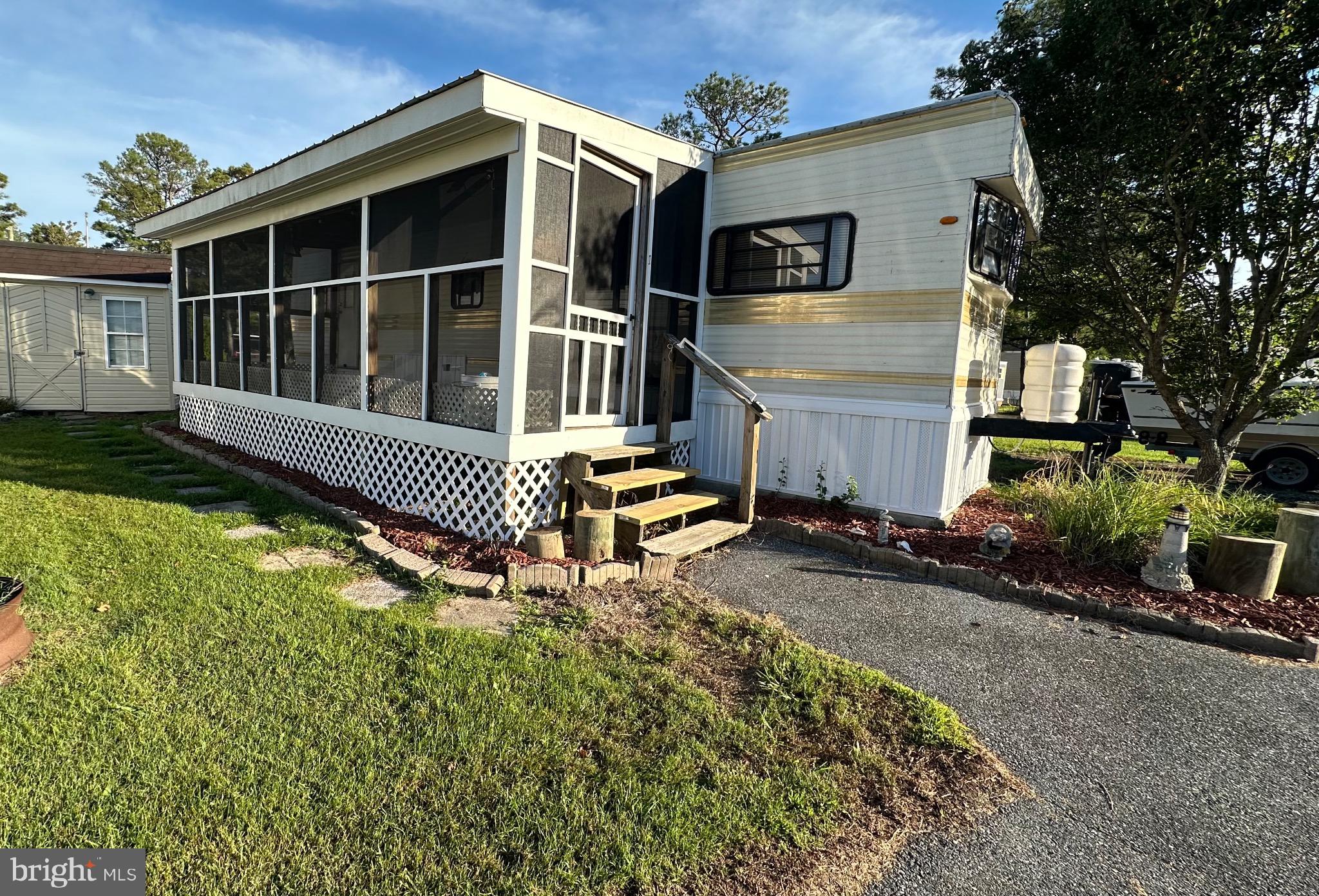 a view of house with backyard and sitting area