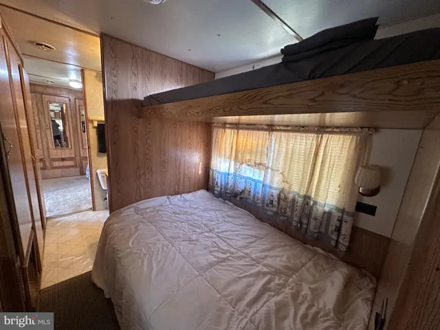 a spacious bedroom with a bed and a large window