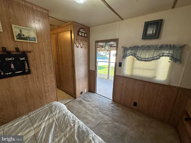 a bedroom with a bed and a mirror