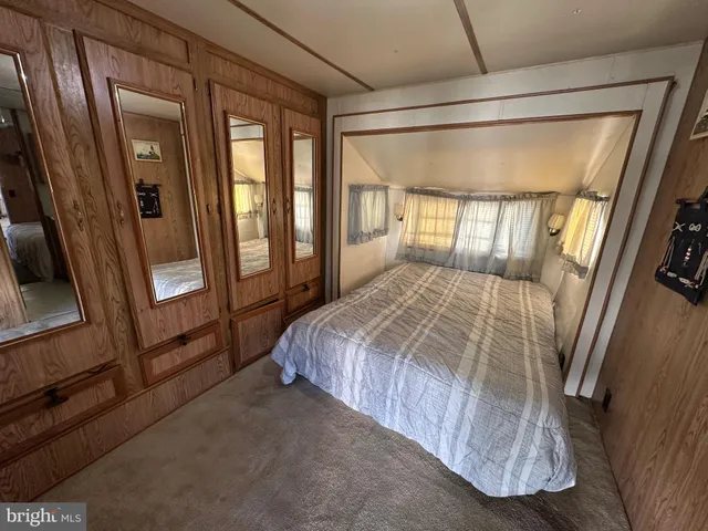 a bed sitting in a bedroom next to a window