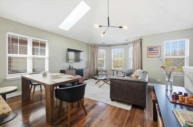 a living room with furniture kitchen view and a flat screen tv