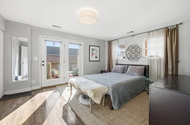 a spacious bedroom with a bed and a dresser