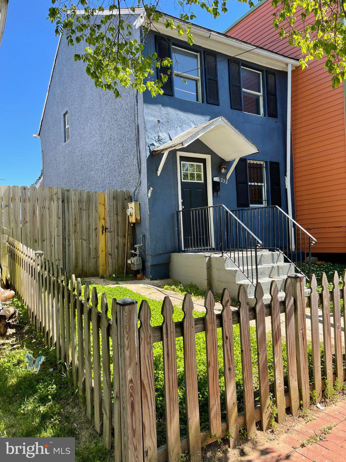 Charming blue home with picket fence.