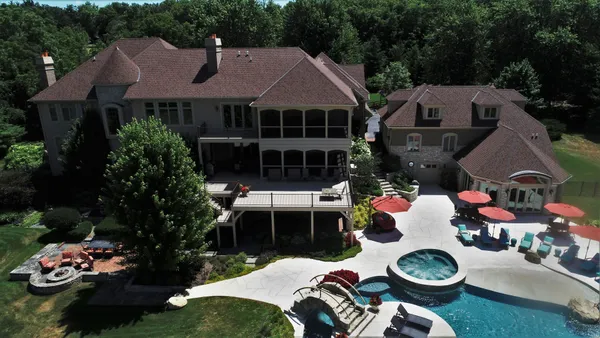 a view of a house with a backyard and a garden