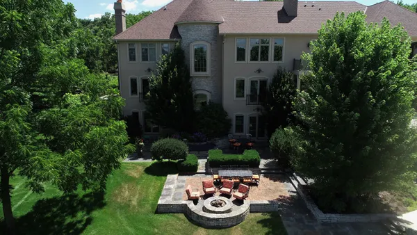 a view of a chair and tables back yard of the house
